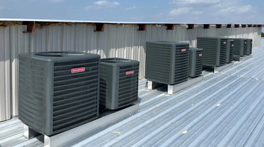 several hvac units sitting on a buildings roof after ac replacement service fort worth tx